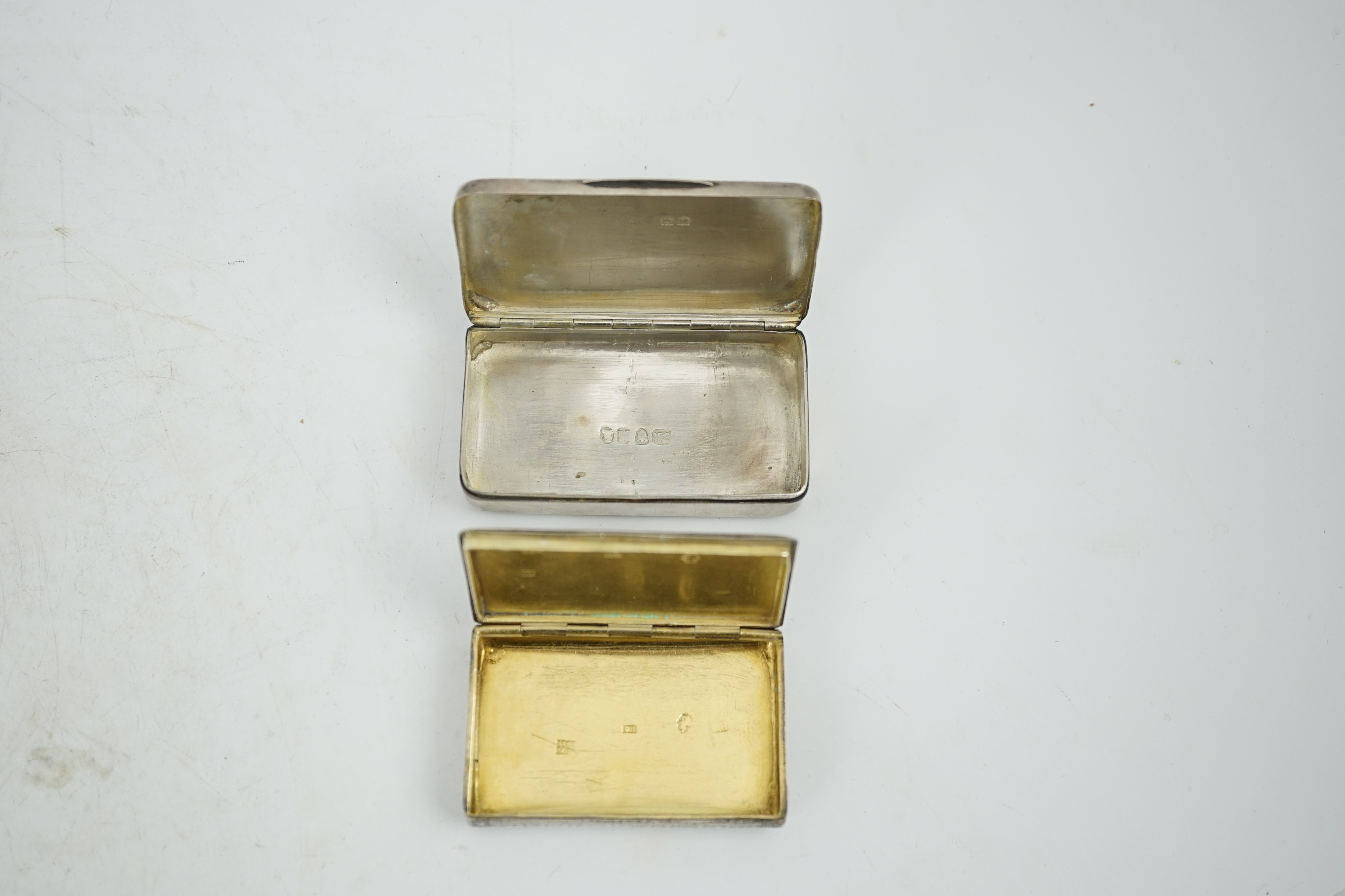 A George III silver snuff box, maker's mark rubbed, London, 1807, 74mm, together with an early 19th century Russian 84 zolotnik snuff box, dated 1819, 64mm.